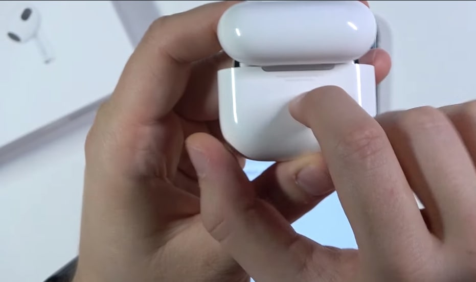 press and hold the setup button on airpods